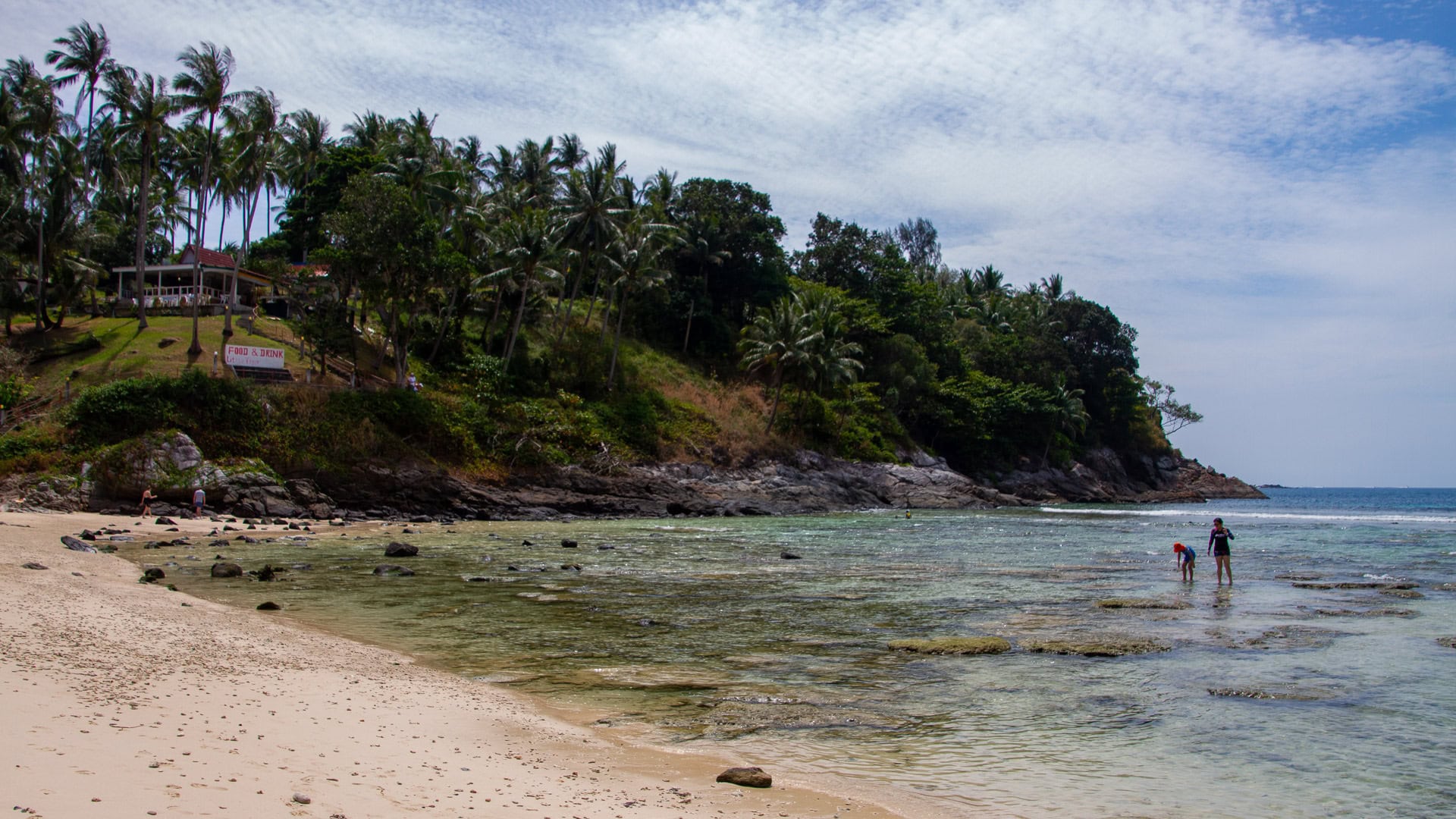 Merlin Beach Phuket with massage huts, trees, and resort frontage