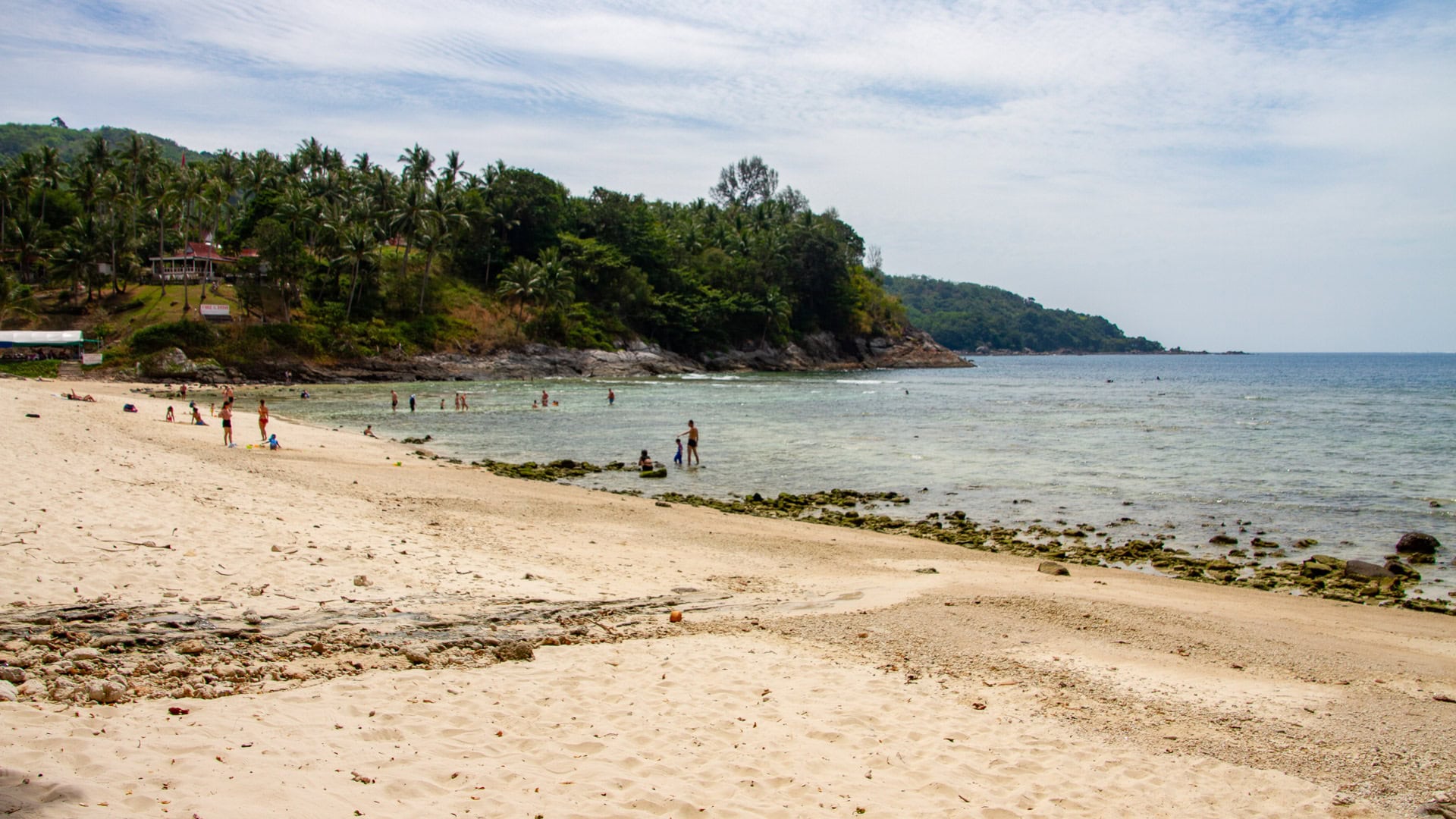 Merlin Beach Phuket rocky edge with shallow water and palm trees